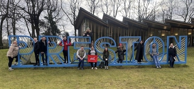 Colleagues posing with a Preston sign