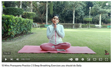 Photo of a person in a garden sitting on a mat demonstrating the 15 mins pranayama practice